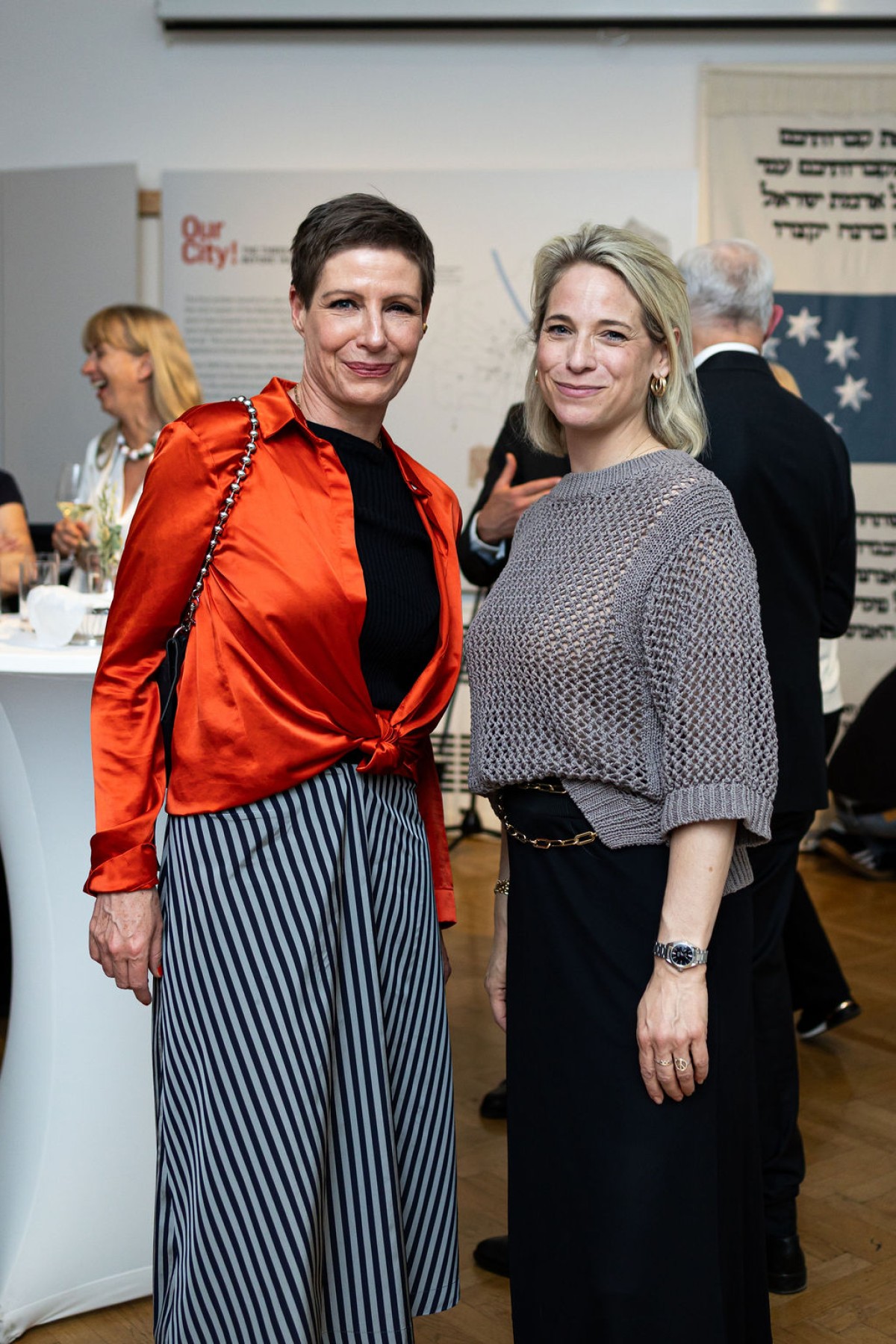 : Two women smile into the camera